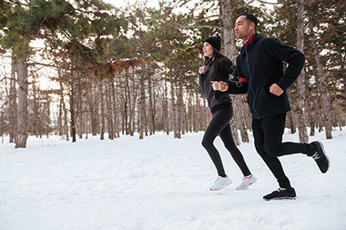 Image of couple jogging in the winter.