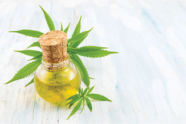 CBD oil in small glass jar.