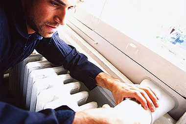 Image of a man cleaning dryer duct.