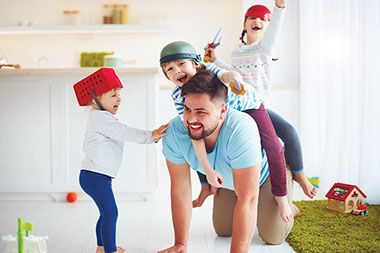 Dad playing with his 3 young kids.
