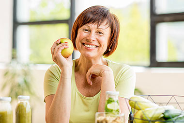 Smiling women with an apple. Smiling women with an apple.