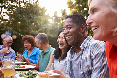 Group of friends enjoying a meal outdoors.