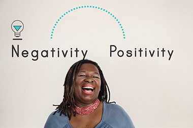 Image of laughing women with the words "Negativity" and "Positivity" written above her. Image of laughing women with the words "Negativity" and "Positivity" written above her.