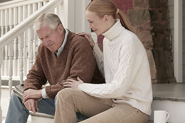 Image of father and daughter sitting on stairs.