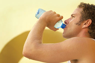 Image of man drinking from a water bottle.