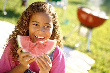 Image of young girl eating watermelon. Image of young girl eating watermelon.