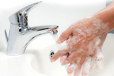 Image of hands being wash with soap and water.