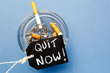Image of quit now tag cigarettes in ashtray. Image of quit now tag cigarettes in ashtray.