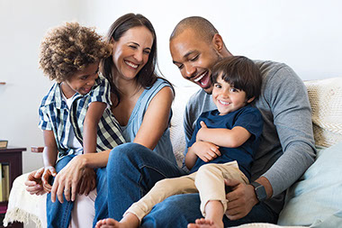 Young family smiling and laughing togething.