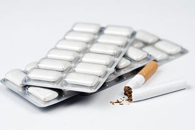 Image of broken cigarette and nicotine gum.