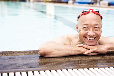 So how (exactly) does exercise help the heart? Image of older man in the swimming pool.