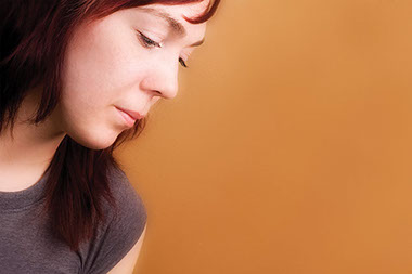 Image of female looking downwards.