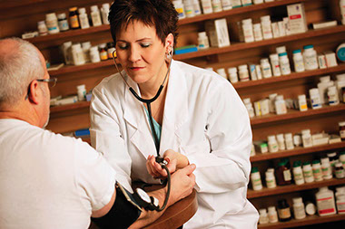 Image of doctor taking a patient's blood pressure reading.
