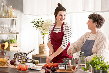 Happy, young woman cooking dinner with grandmother. Happy, young woman cooking dinner with grandmother.