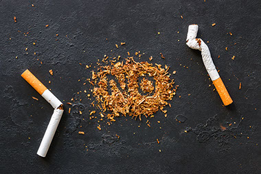 Broken cigarettes with an inscription "no" on tobacco.