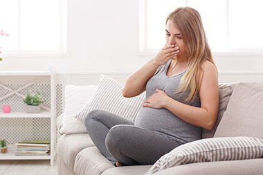 Image of pregnant women feeling nausea.