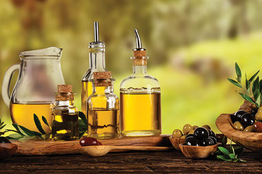 Olive oil bottles on table. Olive oil bottles on table.