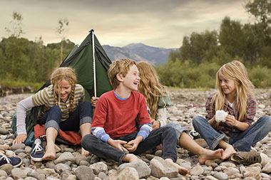 Image of kids hanging around a camp site.