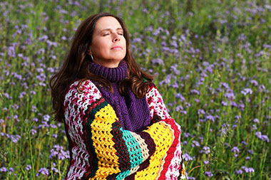 Women doing deep breathing exercises outdoors.