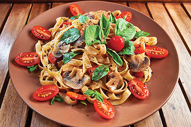 Healthy meal with noodles and fresh vegetables.