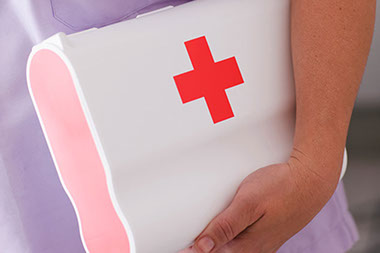 Image of person holding first aid kit.
