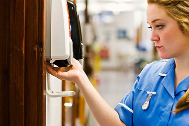 Image of nurse using antibacterial dispenser.