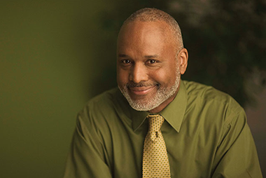 Work the crowd. Image of business man smiling.