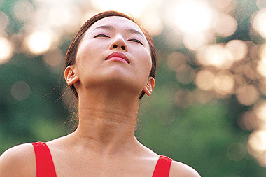 Image of young female breathing in fresh air.
