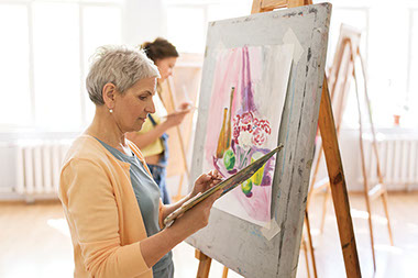 Elderly female painting.