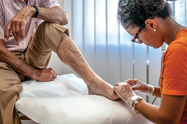 Patient having his foot examined by a doctor.
