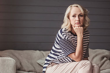 Women sitting looking sad.