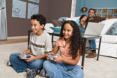 Video warfare. Image of two kids playing video games.