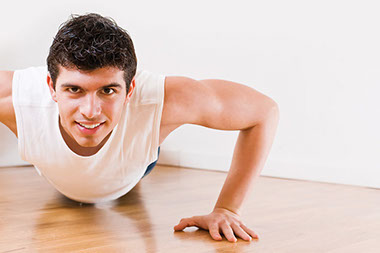Image of young man doing push-ups.