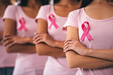 Women wearing pink shirts with pink ribbons.