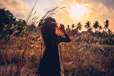 Women walking in field with tall grass. Women walking in field with tall grass.