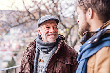 Father and adult son talking.