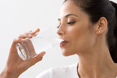 Image of women drinking a glass of water.