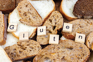 Image of bread with the word 'Gluten' on wooden blocks. Image of bread with the word 'Gluten' on wooden blocks.