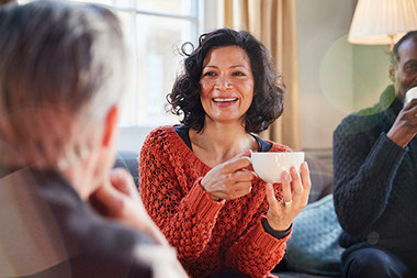 Friends sitting talking and drinking tea.