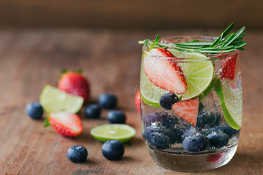 Glass of water with fruit in the glass.