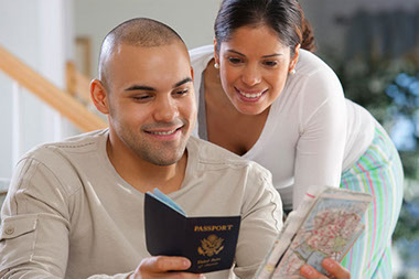Image of couple looking at passport and map.