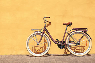 Bike up against a yellow wall. Bike up against a yellow wall.