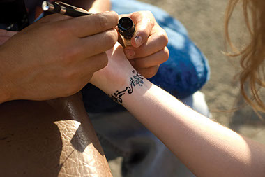 Close up image of wrist getting a temporary tattoo.
