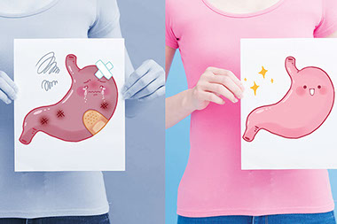 Person holding a paper with a stomach illustration, one half happy stomach the other half a sick stomach.