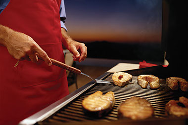 Close up image of a person grilling.