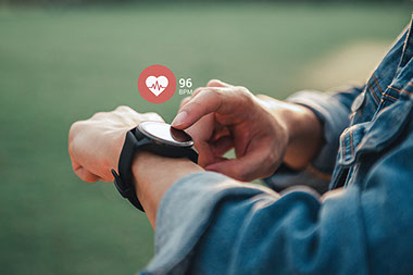 Close up of man using smart watch with heart beat showing at 96 bpm. Close up of man using smart watch with heart beat showing at 96 bpm.