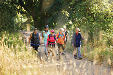 Group of friends walking on a trail.
