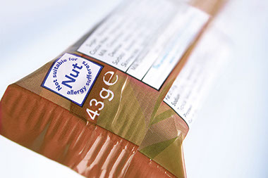 Image of candy bar with warning "Not suitable for Nut allergy sufferers."