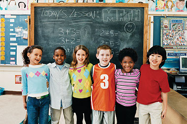 Pay attention. Image of kids in a classroom.