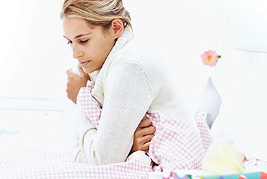 Image of women sick in bed.